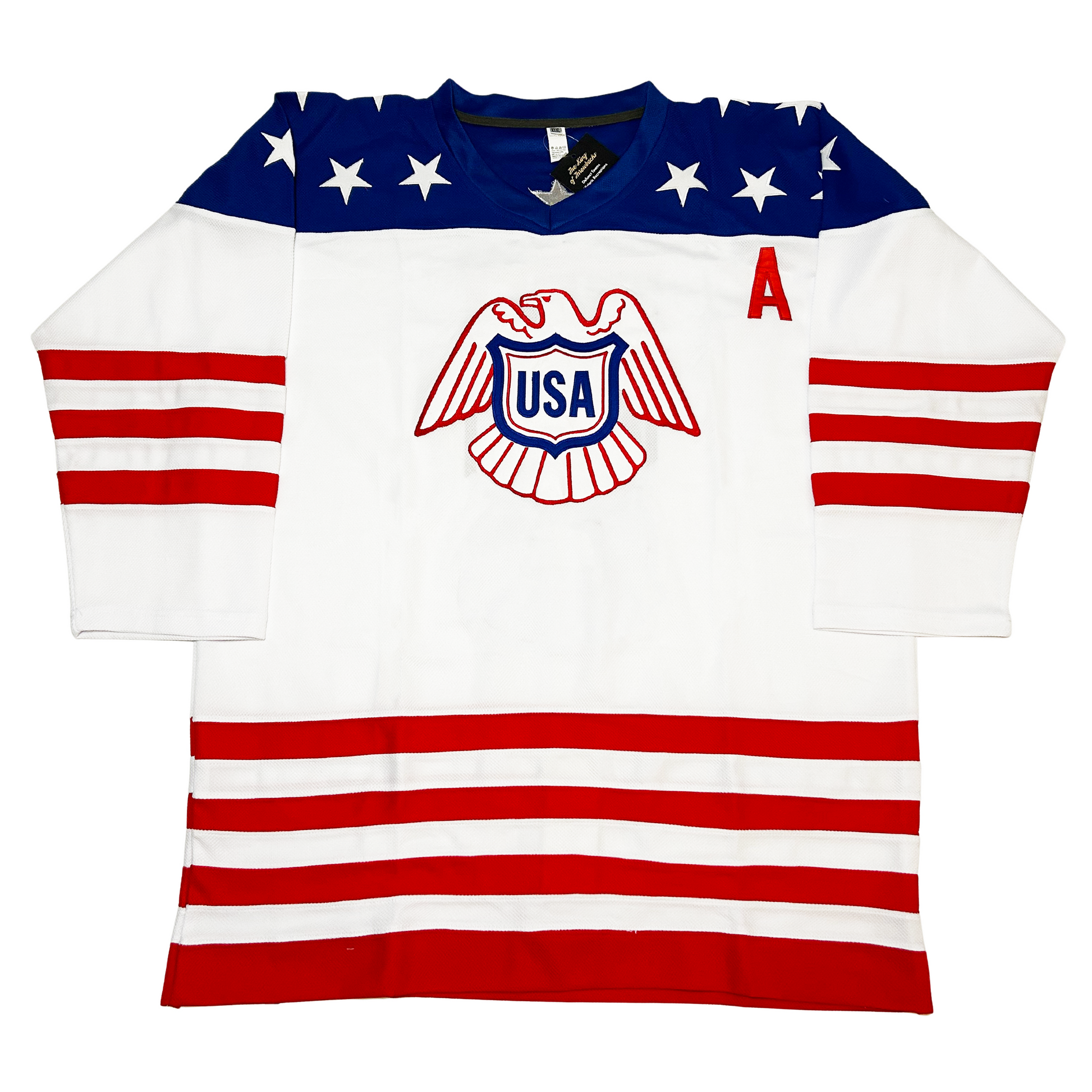 1976 USA Canada Cup Jersey. Blue. Three red bands on sleeves, four on waist. Eagle line drawing in red on chest with USA shield in blue. Co-captain A on left chest. Blue shoulders with white stars. Royal Retros