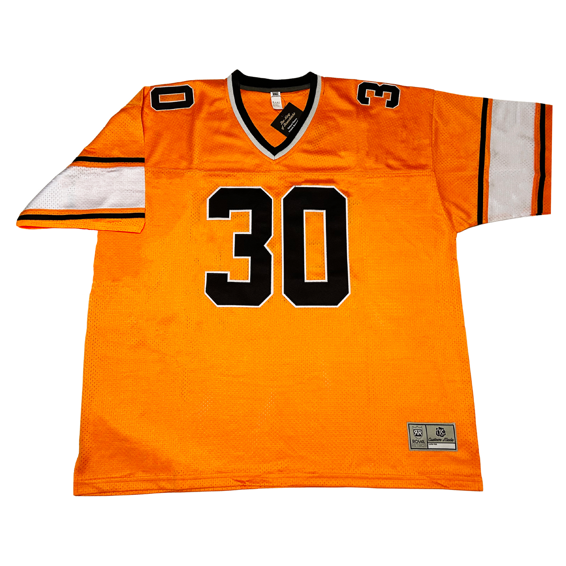 1977 B.C. Lions jersey orange. Black and white collar. Thin black, orange, thick white, thin orange, thin black bands above sleeve ends. Black #30 with white trim large on chest, small on shoulders  Royal Retros