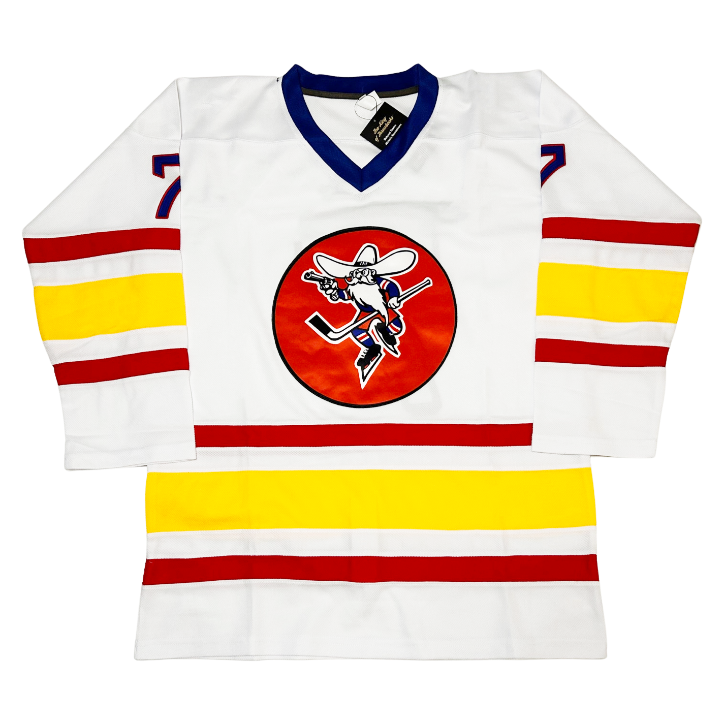 Albuquerque Six-Guns Jersey Hockey front. White. Blue collar. Small red, white, large gold, small white, small red bands mid-sleeve and just above waist. Red circle on chest with cowboy with broad brim hat in skates holding a six shooter and hockey stick. #7 in blue with red trim, small on shoulders. Royal Retros.