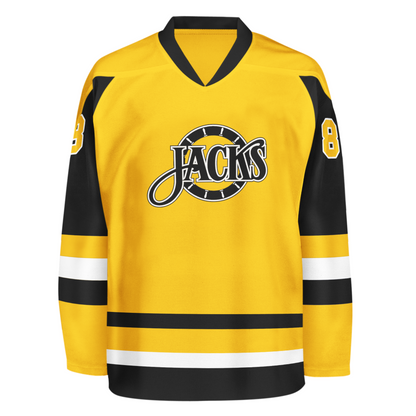 Baltimore Skipjacks jersey. Gold. Black collar. Black upper sleeve, gold lower, with gold, white, white bands mid-sleeve and around waist. Baltimore n white arched above stylized Jacks logo. Jacks in black with gold trim over yellow ship's wheel. #8 in gold white trim on shoulders. Royal Retros.