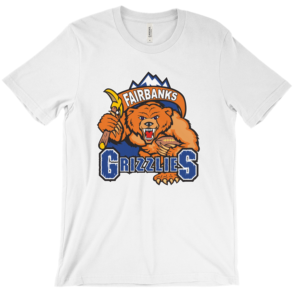 Fairbanks Grizzlies T-shirt. White. Mountain peaks with brown banner with Fairbanks in white inside. Below, a growling bear, face on, holding a pick in his right arm and a football in his left over GRIZZLIES on blue with white trim. Royal Retros 