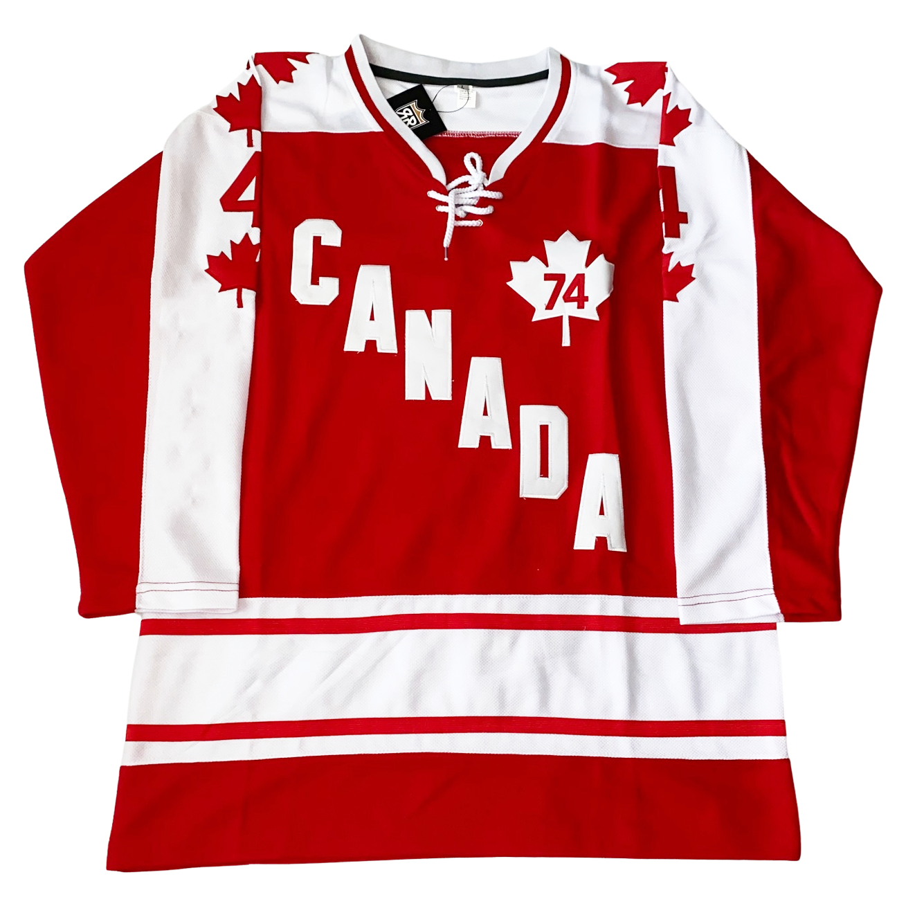 1974 Team Canada hockey jersey. Red. White and red color. Half red, half white sleeves. Red maple leaves down white side with #44 red above last one. Red and white bands above waist. Canada diagonal down lef to right in white. White maple leaf with red 74 inside upper left chest. Royal Retros