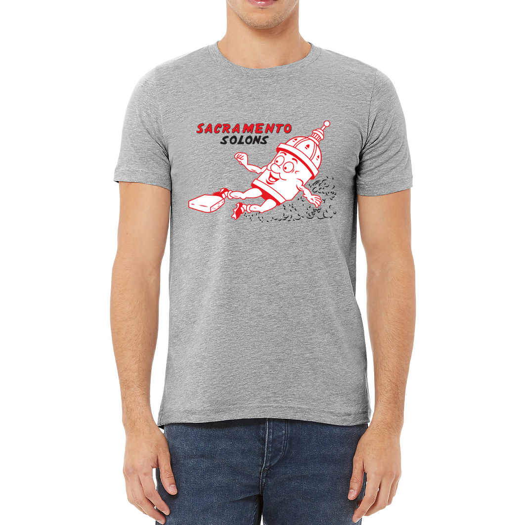 Sacramento Solons T-shirt. Gray. Sacramento in red, Solons in black below on right chest. Image of cartoon capital building, white with red detail,  sliding into a base, right to left. Royal Retros