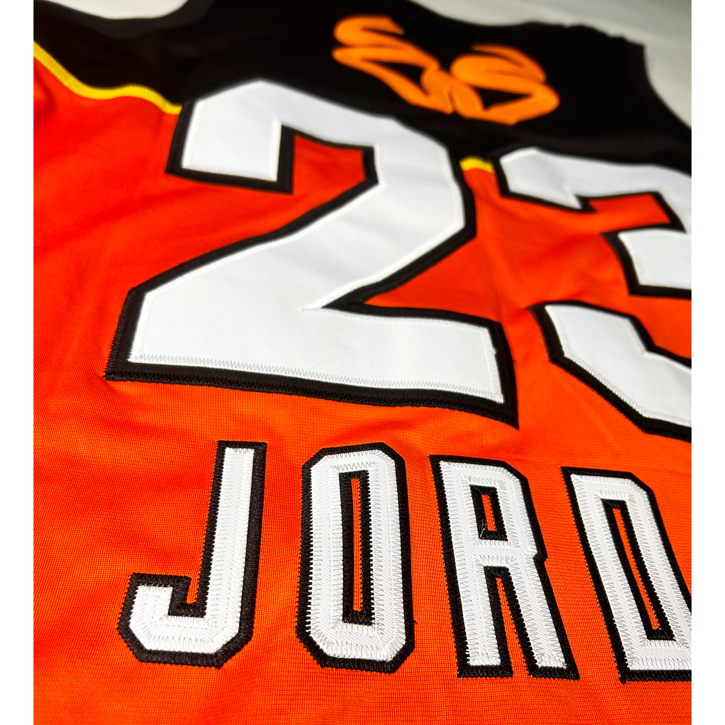 Stefanel Trieste Jersey #23. Black on top, orange bottom. Back view Jordan Royal Retros