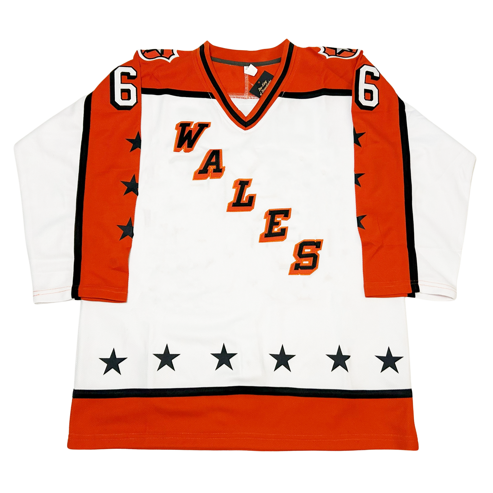 Prince of Wales Conference All-Star Hockey Jersey. White. Orange shoulders and half orange sleeves with black trim. 3 black stars on orange part of sleeves. WALES diagonal left down to right, black letters with orange trim. Thin black and wide orange band at waist. Orange, black, and orange collar. 6 stars above bands on waist. #66 in white with black trim on sleeves. Royal Retros.