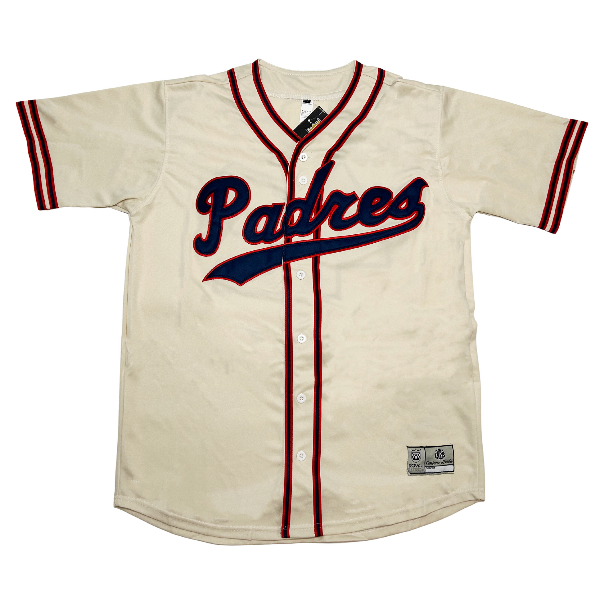 PCL Padres Home button-down 1950 white jersey. Padres in cursive, blue with red trim with a text tail below. Red and blue sleeve ends and red and blue piping around neck and down both sides of buttons.  Royal Retros