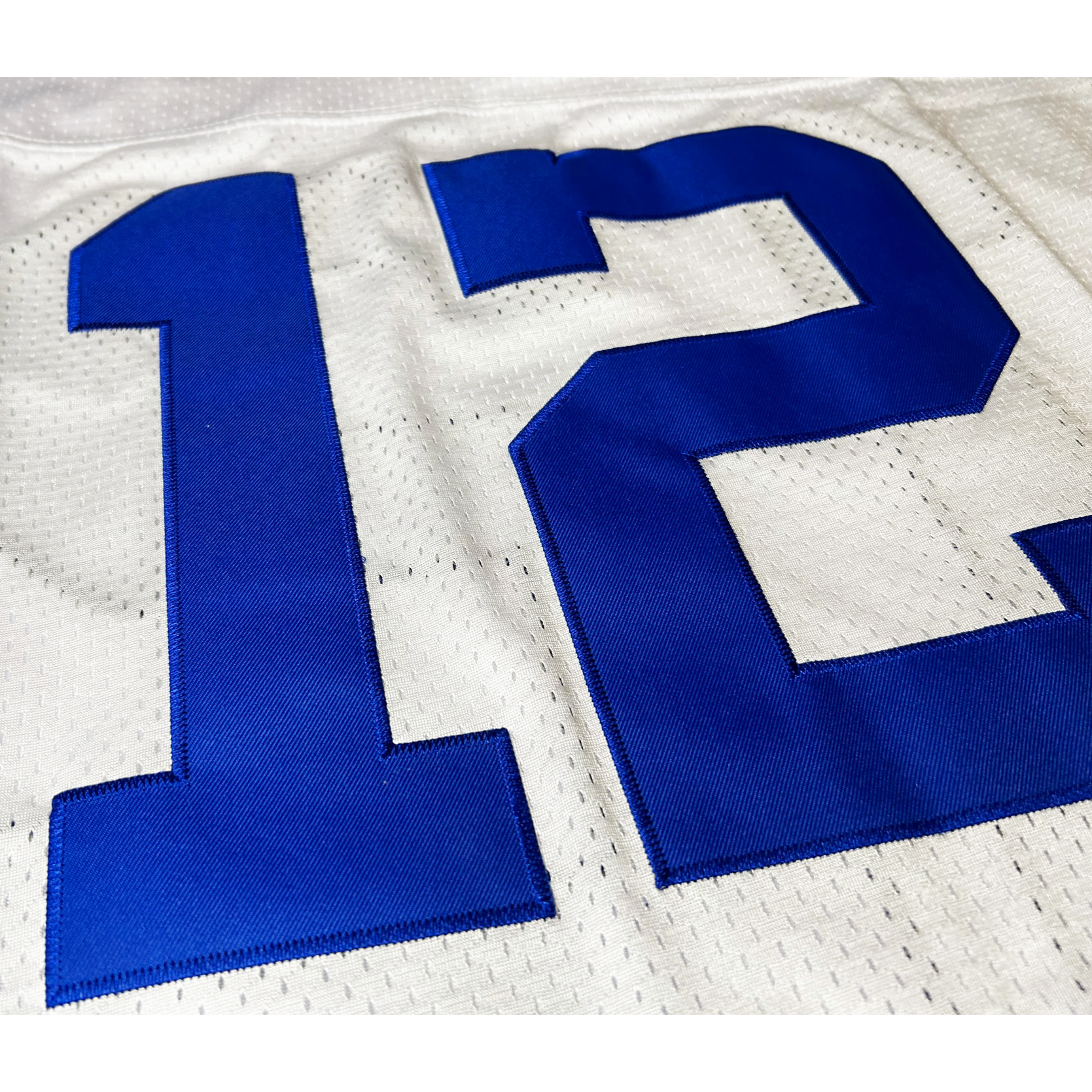 1960s Dallas Cowboys jersey close-up of stitching. Blue #12 on white. Royal Retros