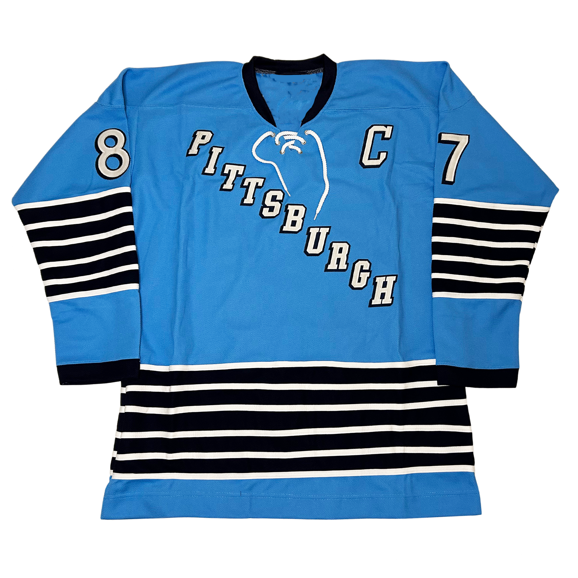 967 Pittsburgh Penguins jersey. Blue. Black collar and sleeve ends. PITTSBURGH in blue diagonal top left to bottom right in white with black trim. Thin white, thick black alternating bands 5 times at mid-sleeve and around waist. #87 white with black trim on upper sleeve. Captain's C white with black trim on upper left chest. Royal Retros