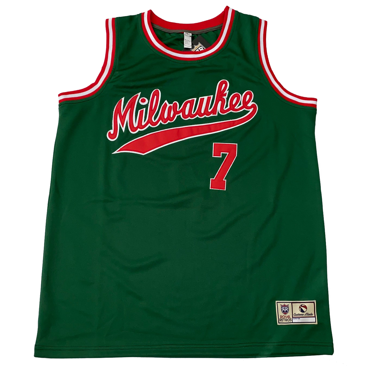 1975 Milwaukee Bucks basketball jersey. Green. Red, white, and red trim at shoulders and collar. Milwaukee in cursive with text tail, red with white trim.  #7 below right red with white trim. Royal Retros