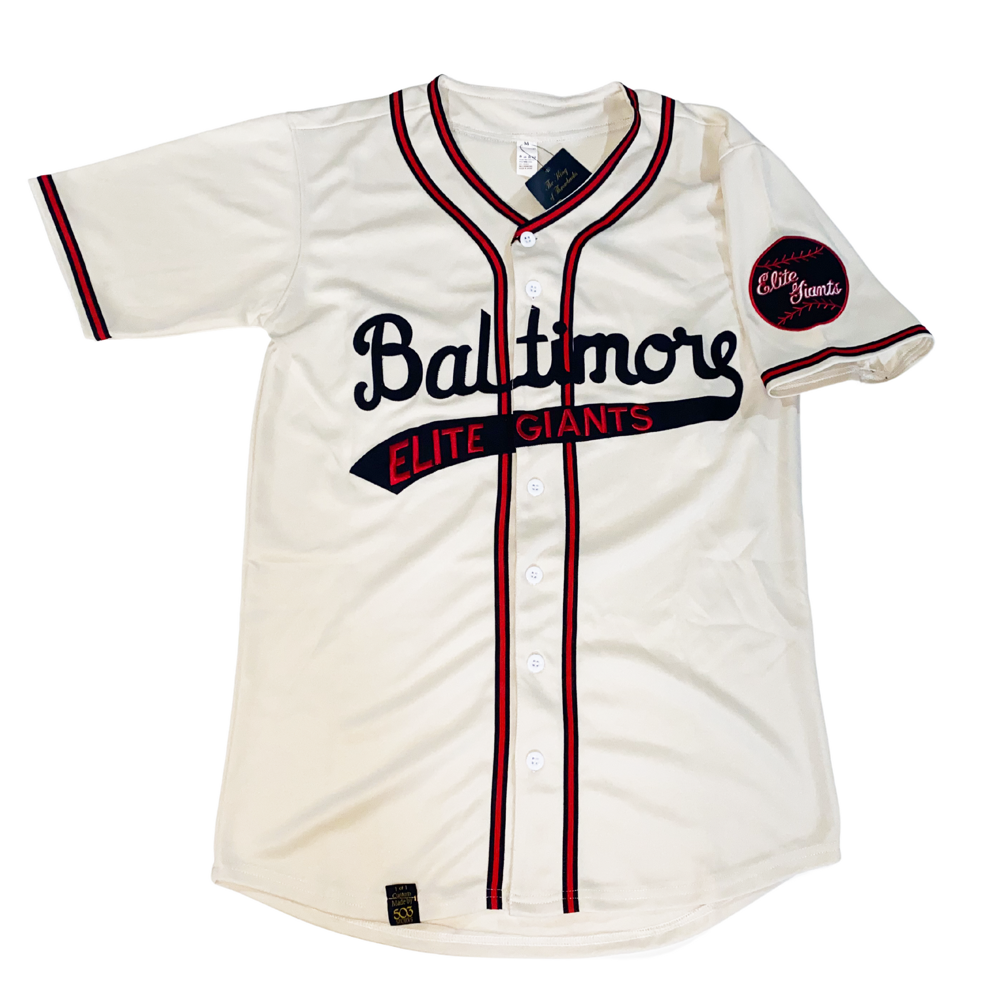 baltimore elte giants negro league button-up jersey. White. Black, red, and black stripes around sleeves, around neck and down both sides. Baltimore in cursive in black across chest with text tail Elite Giants on red in text tail. Royal Retros