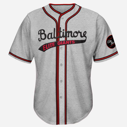 baltimore elte giants negro league baseball jersey. Pepper gray. Red, black, and red stripes around sleeve ends, around neck and down both sides of buttons. Baltimore in black cursive across chest with text tail. Elite Giants in red in text tail. Royal Retros.