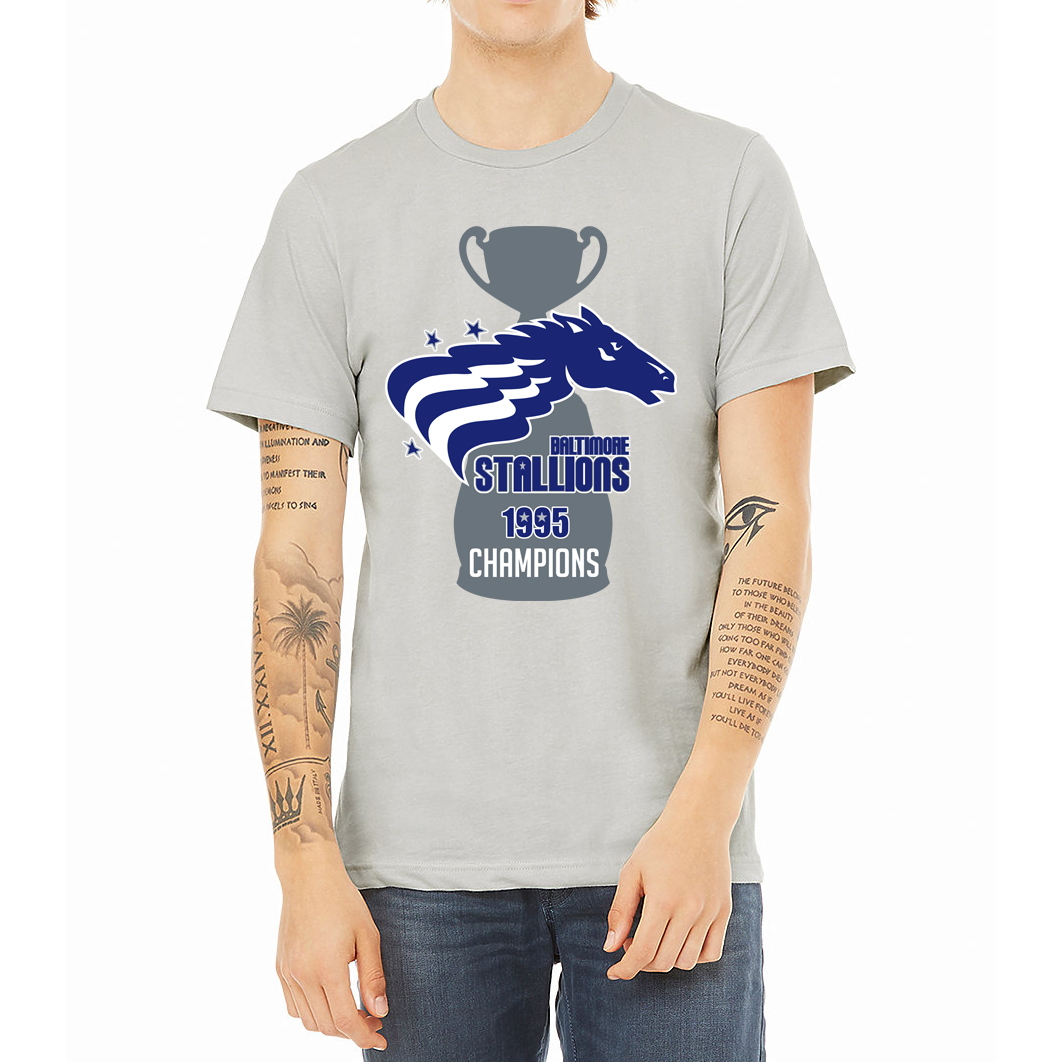 Baltimore Stallions Champions Shirt grey. Dark gray trophy with Stallions horsehead logo over top. Horse's main is alternating blue and white stripes. Baltimore Stallions 1995 in blue with white trim below horse. "Champions" in white below on base of trophy. Royal Retros