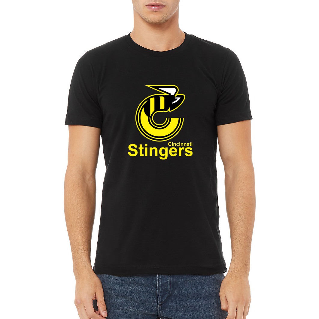 Cincinnati Stingers Black T-shirt . Logo consists of the depiction of a bee in the shape of the letter "C". To the right and below the bee depiction is the literal element "CINCINNATI". The literal element "STINGERS" appears below "CINCINNATI". Royal Retros