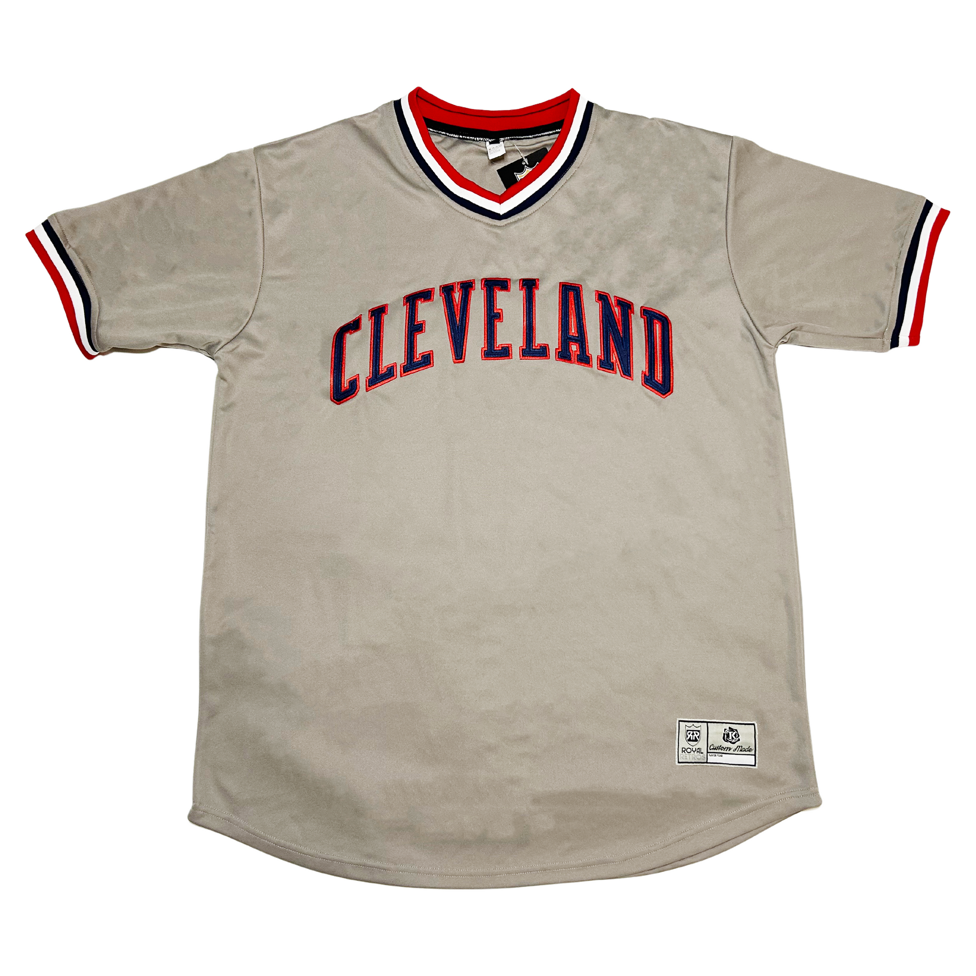 1980s Cleveland Baseball Jersey gray with red white and blue trim on neck and sleeves. Cleveland in blue with red trim across chest. Royal Retros