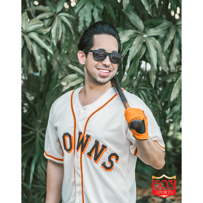 Fan wearing St Louis Browns Block Letters Jersey white with orange and brown piping. Browns across chest in Brown with orange trim home Royal Retros