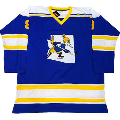 Phoenix Roadrunners Jersey blue. Gold trim on next. White gold, white, gold, white band around sleeves and waist. White shoulders with blue and gold  trim. Logo on chest of roadrunner holding a hockey stick over white outline of Arizona.  Royal Retros