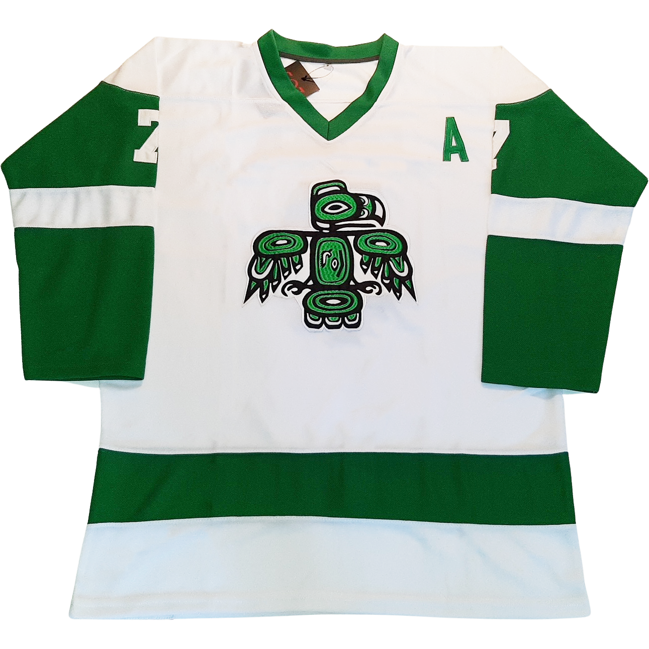 Seattle Totems Jersey white. Green sleeves with white band in middle of sleeves. Green collar. Green band around waist. Thunderbird logo with green and black elements on chest. Co-Captain's A on upper chest. #7 in white on sleeves. Royal Retros